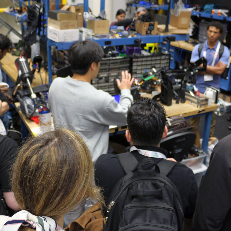 Graduate Student leading a tour of an assitive robotics lab