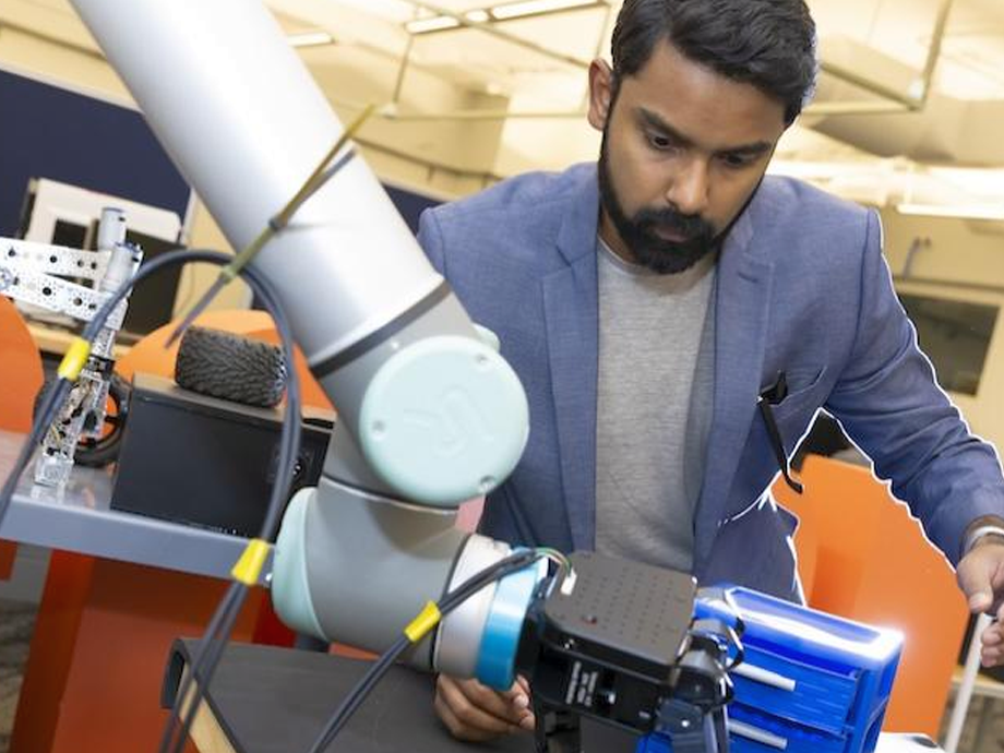 man working with a robotic arm