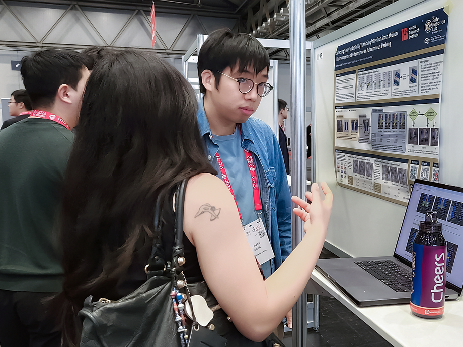 students at a poster exhibit looking at a poster