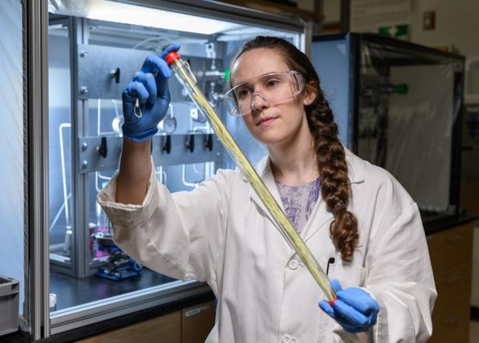 Georgia Tech grad student holding a hollow fiber membrane that can be used for low-energy chemical separation.